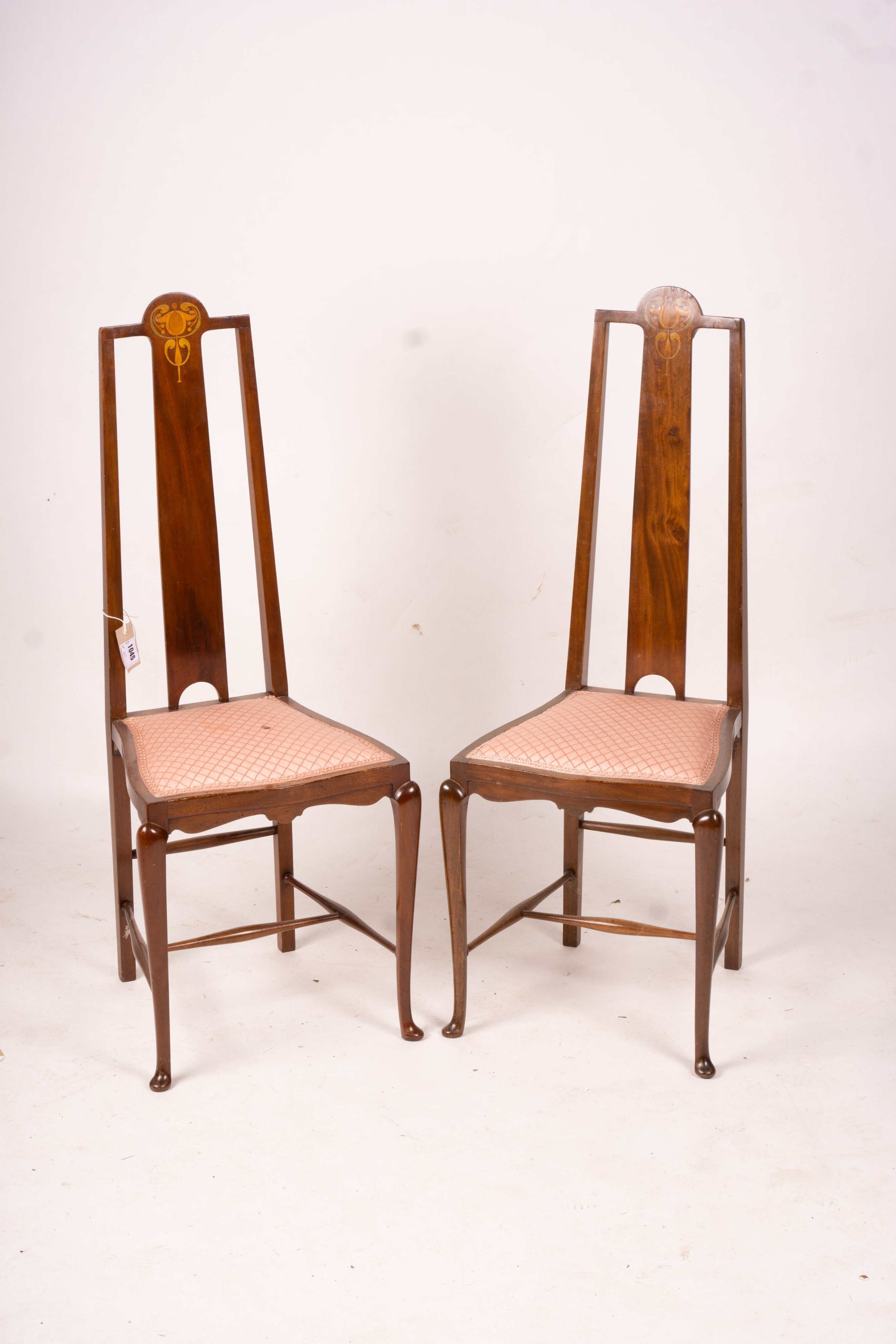 An Edwardian Art Nouveau inlaid mahogany towel rail and a pair of matching salon chairs (3)